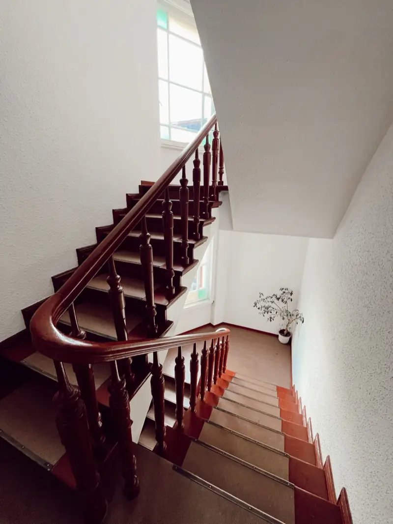 Altbau-Treppe mit Holzstufen und gedrechseltem Geländer
